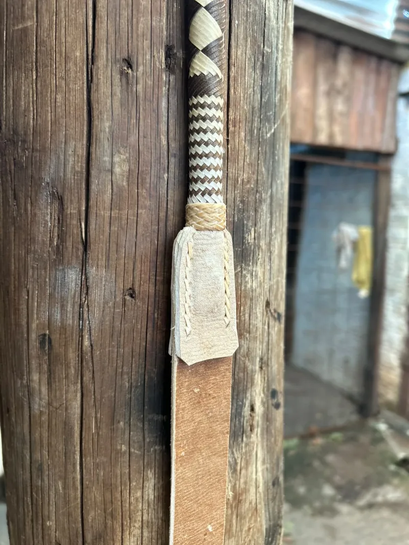 Detalhe da emenda do cabo trançado com a pala de couro cru costurada