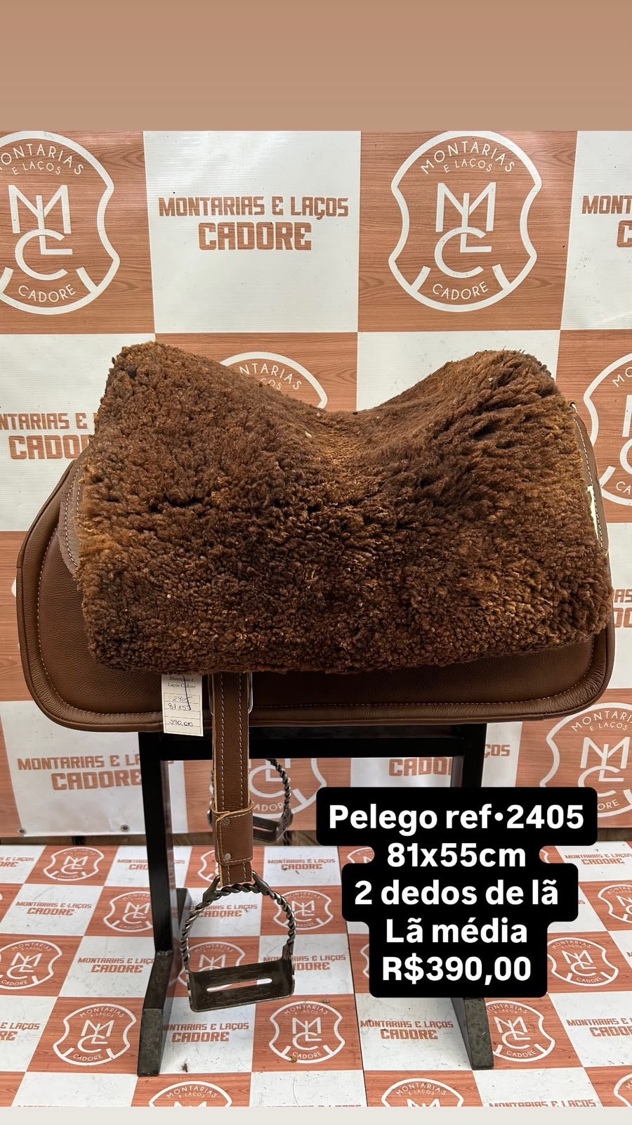Pelego de lã sobre uma sela no cavalete, com a referência 2405, a medida e o preço escritos na foto